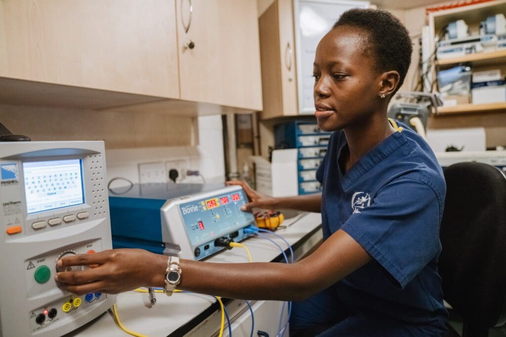 Deborah Nutsugah, Biomedical Technician and one of the mercy ships engineers, troubleshooting on equipment in the Biomedical Office.