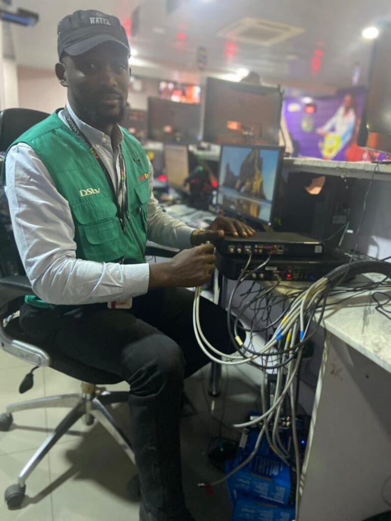 Chidiogo Okoli Field Engineer Broadcast Media at desk fixing box