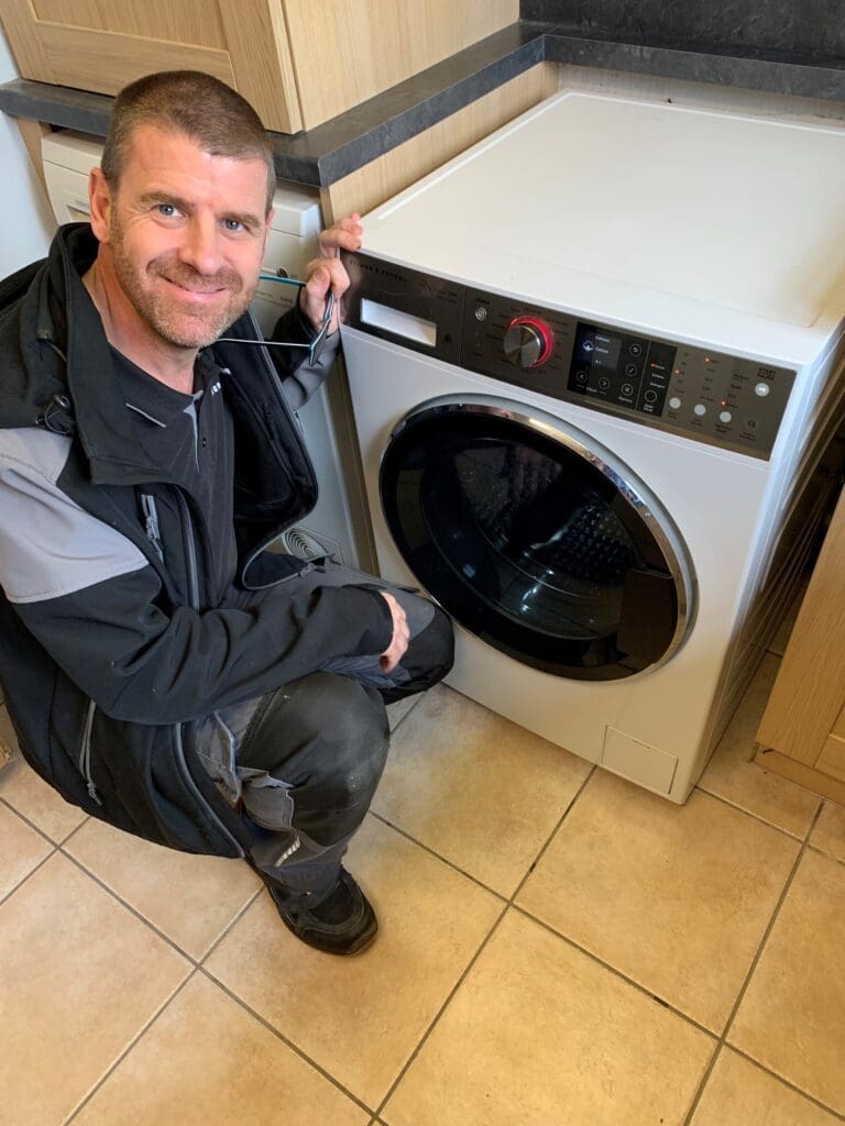 Paul Summerhayes  Field Service Technician Fisher and Paykel with washing machine