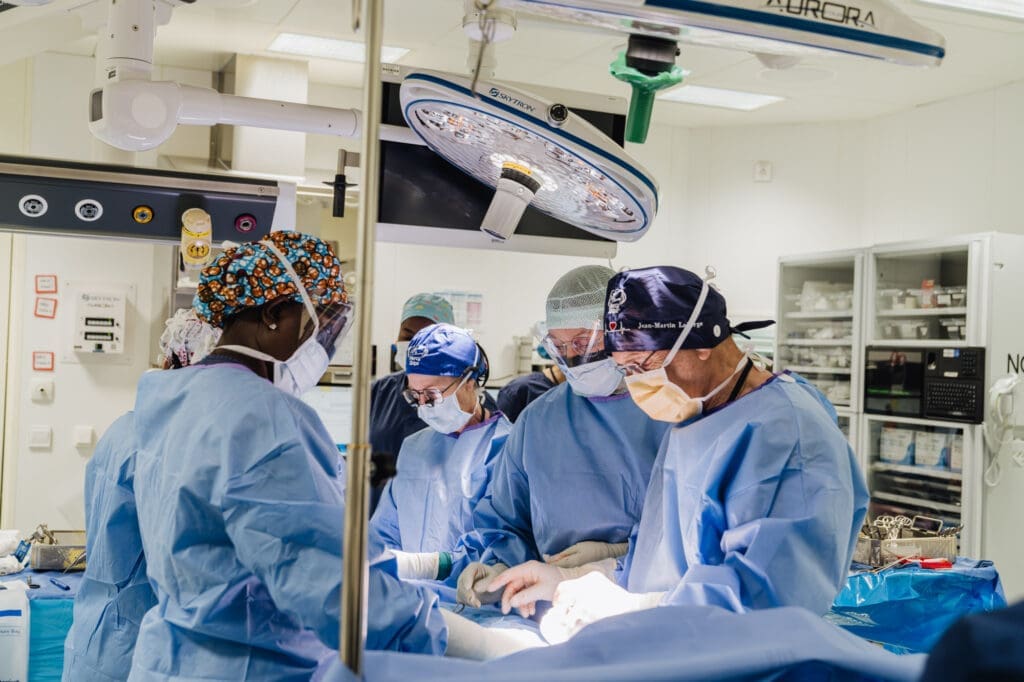 Louise Caouette Laberge, Reconstructive Plastic Surgeon at work with her husband Jean-Martin Laberge Pediatric Surgeon using equipment maintained by Biomedical Technicians working on Mercy Ships