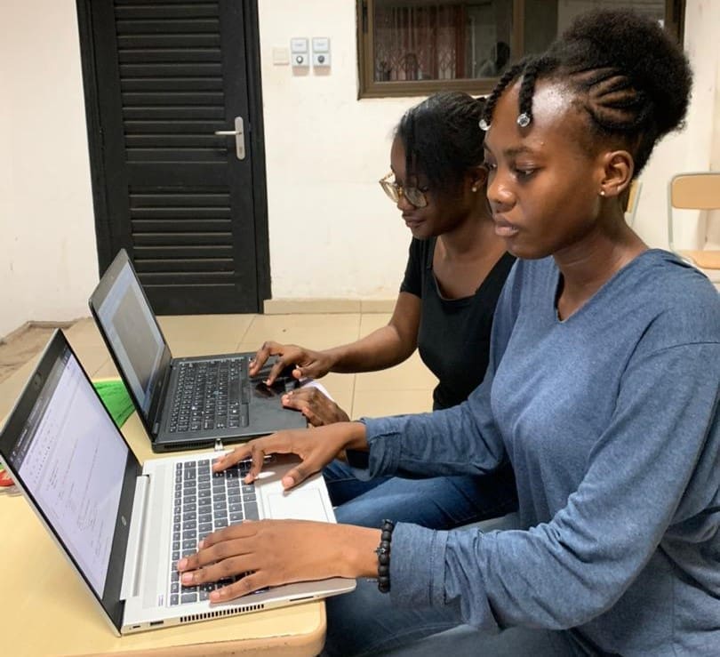 Ethel Enam Abla Nyamador and Efua Kusiwa Aboagye biomedical engineers working at laptops