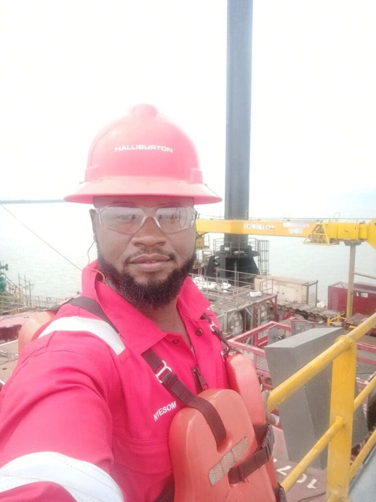 Kingsley James Well Intervention Engineer Halliburton with crane and oil well
