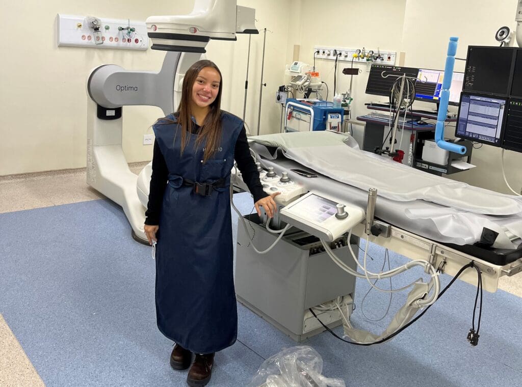 Lorena Leal Dos Santos with GE Optima Healthcare equipment
