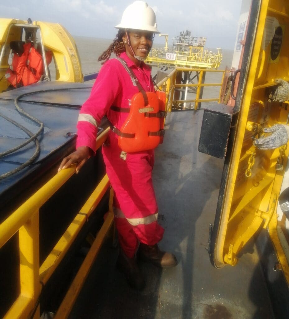 Peninnah Isom Akumute woman coiled tubing field service engineer working with oil well in background