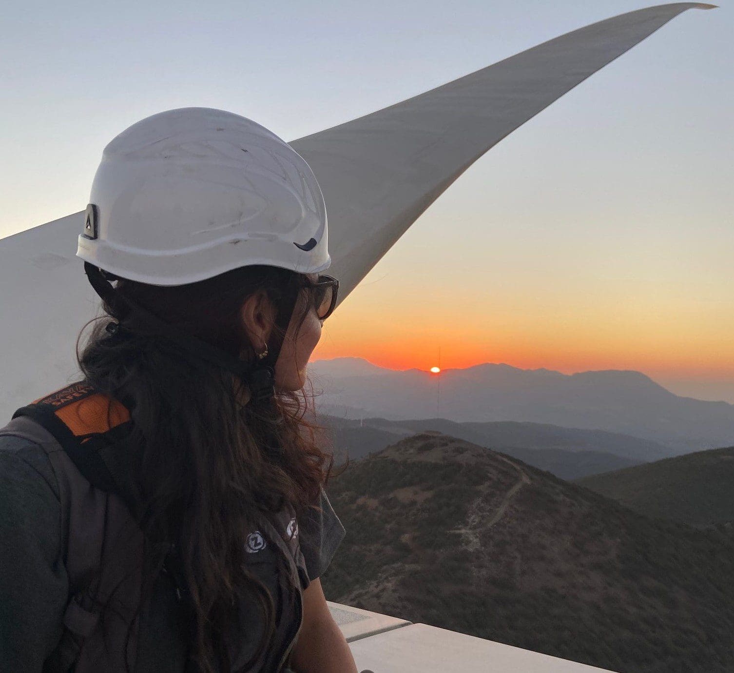 Songul Ogdum on wind turbine with sunset