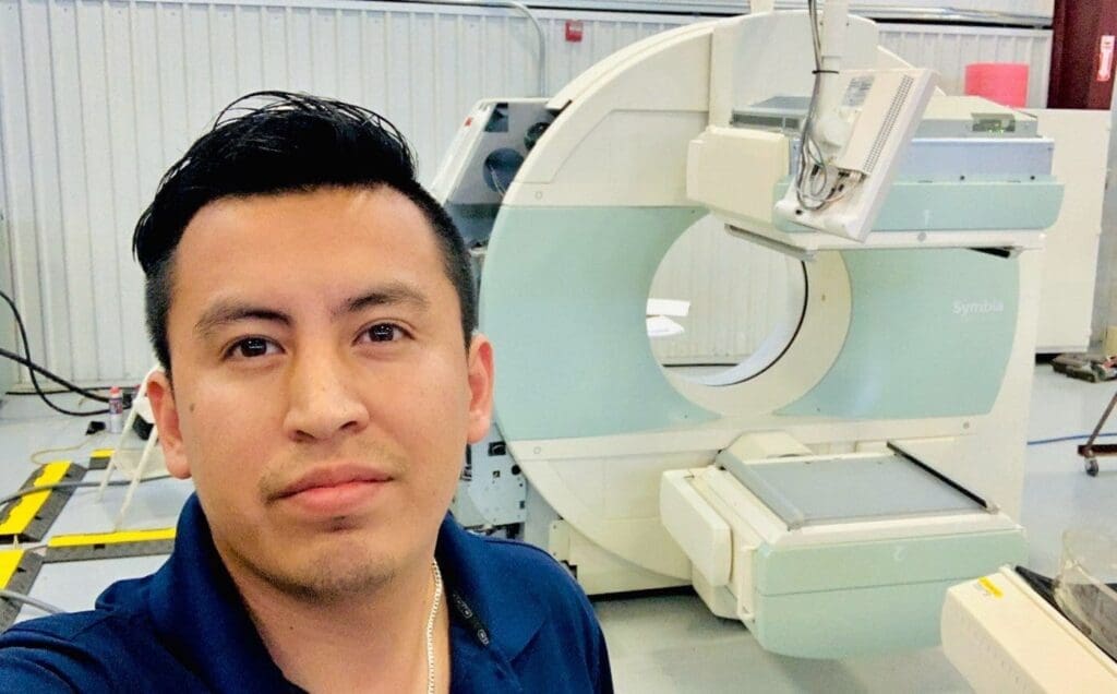 Daniel Garcia Valerio Professional service engineer in nuclear medicine PETCT CT microPET and Cyclotron system Texas in front of CT Scanner